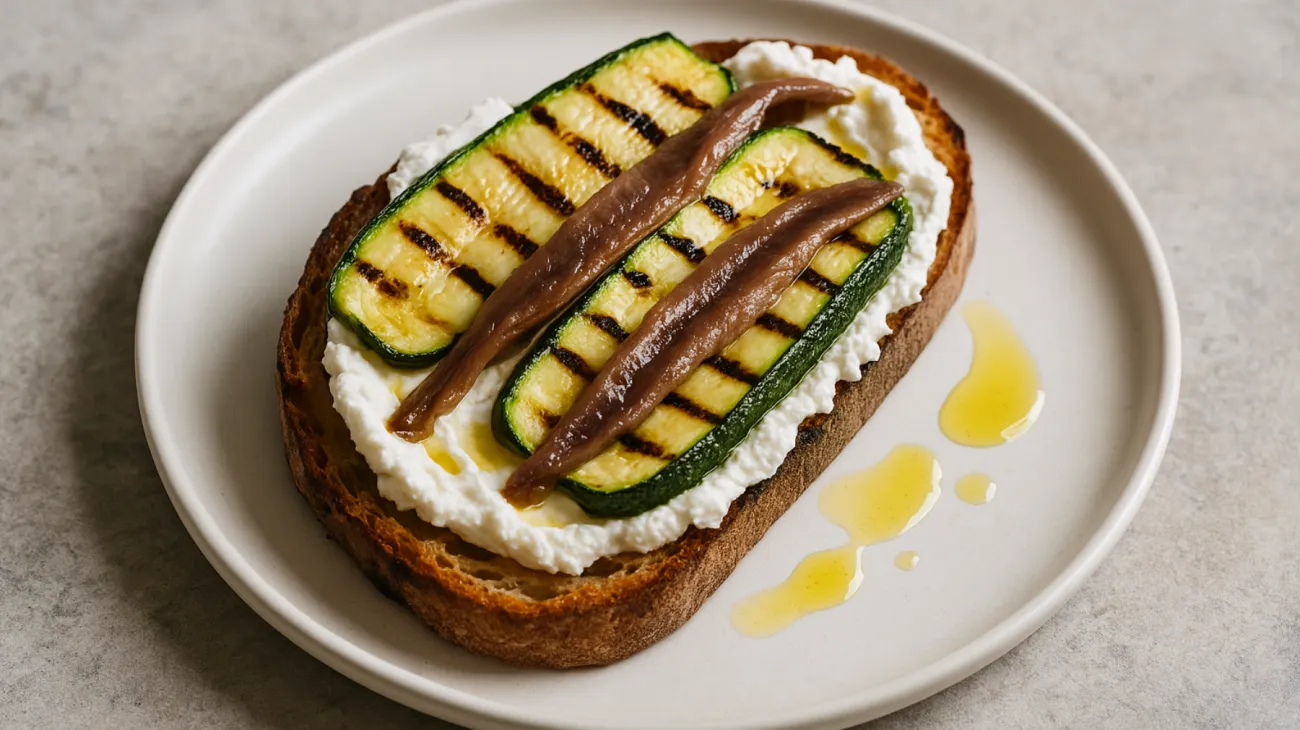 Pane cunzato ricotta acciughe zucchine grigliate"